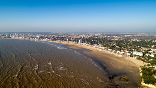 High angle view of sea and cityscape against sky