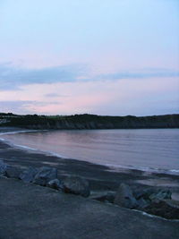 Scenic view of beach against sky during sunset