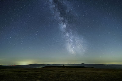 Scenic view of landscape against sky at night