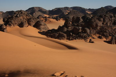 Scenic view of desert against clear sky acacus mountain, libya