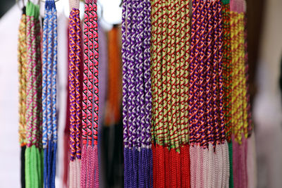 Close-up of multi colored bracelets hanging in store for sale