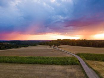 Scenic view of field against sky during sunset