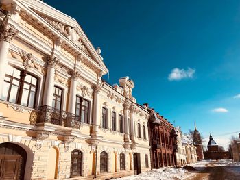 Low angle view of historical building against blue sky