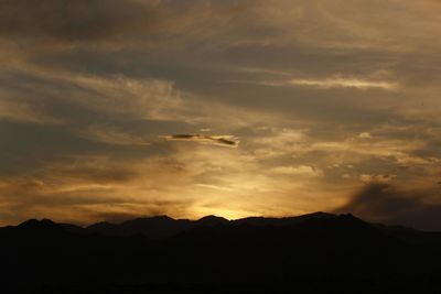 Scenic view of silhouette mountains against sky during sunset