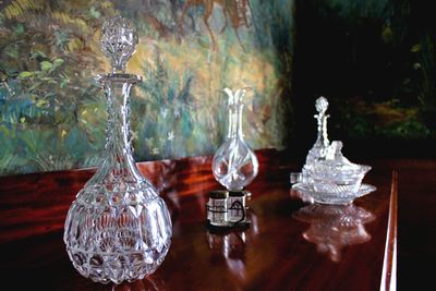 Close-up of ancient glasses on table