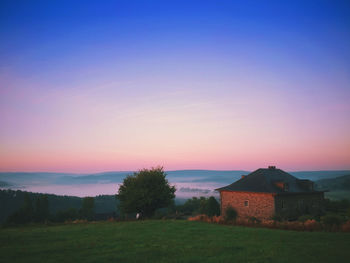 Scenic view of landscape against sky at sunset