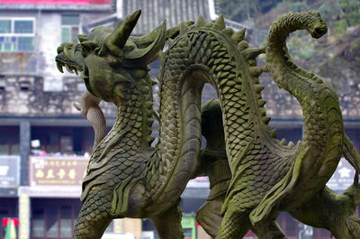 Close-up of angel statue against temple