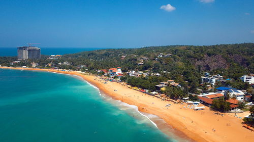 High angle view of swimming pool by sea against blue sky