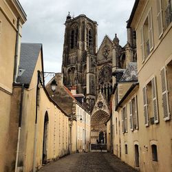 Street in town against sky in city