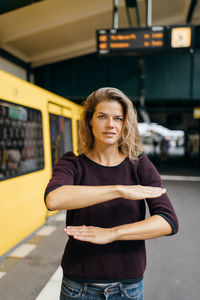 Portrait of beautiful woman standing in bus