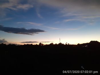 Silhouette of tower against sky during sunset