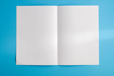 Directly above shot of book against blue background