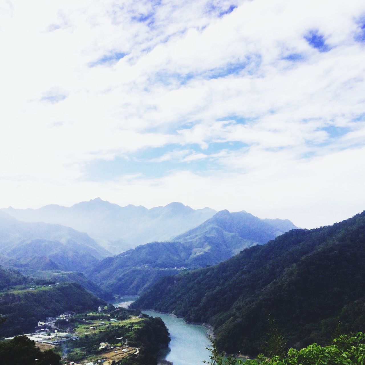 mountain, mountain range, tranquil scene, scenics, tranquility, water, beauty in nature, sky, nature, landscape, lake, cloud - sky, river, idyllic, non-urban scene, cloud, outdoors, day, cloudy, high angle view