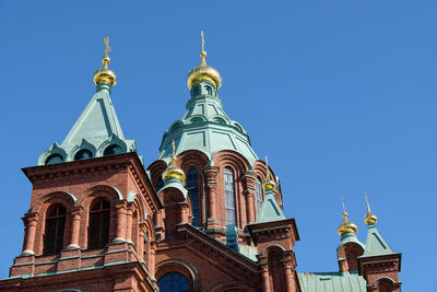 Low angle view of buildings against blue sky