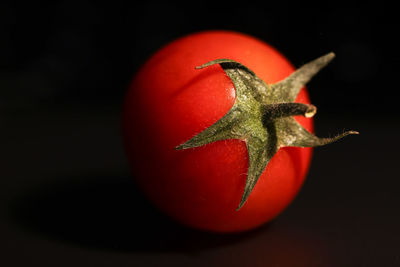 Close-up of tomato against black background