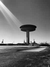 Tower on field against clear sky