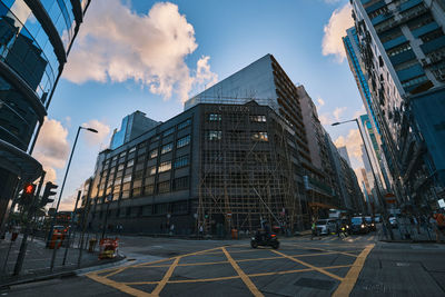 View of city street and buildings against sky