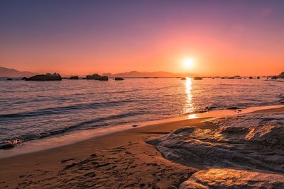 Scenic view of beach at sunset