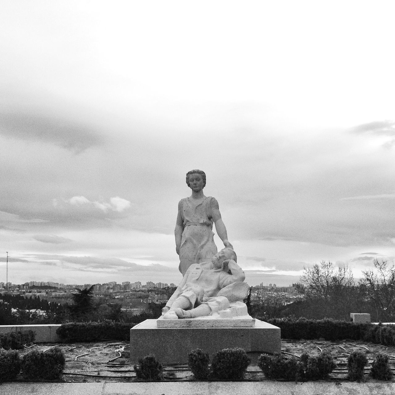 sky, rock - object, water, tranquility, human representation, stone - object, leisure activity, tranquil scene, lifestyles, nature, stack, cloud - sky, standing, scenics, day, sitting, rear view