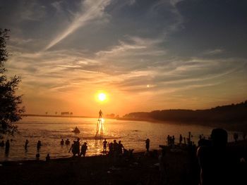 People on beach at sunset
