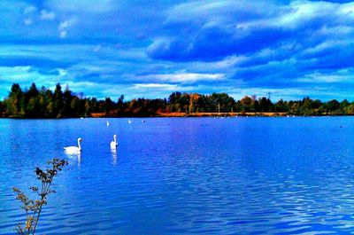 Scenic view of lake against cloudy sky