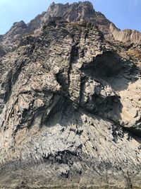 Low angle view of rock formation on land against sky