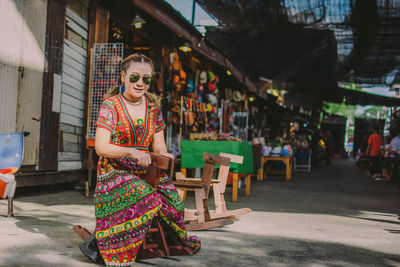 Portrait of smiling woman sitting on rocking horse