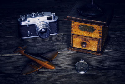 Close-up camera and pocket watch on table