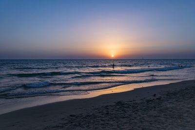 Scenic view of sea against clear sky during sunset