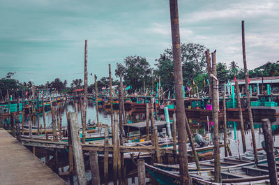 Boats moored in canal against sky