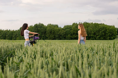 Rear view of woman walking on field