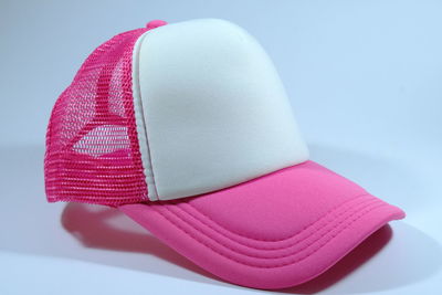 Close-up of hat against pink background