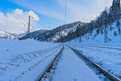 Railroad passing between mountains in winter