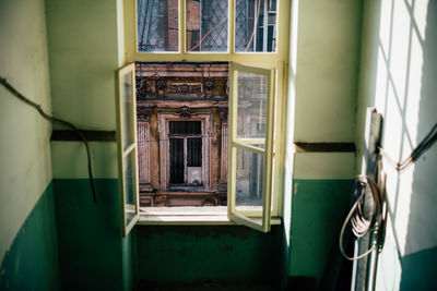 Building seen through open window