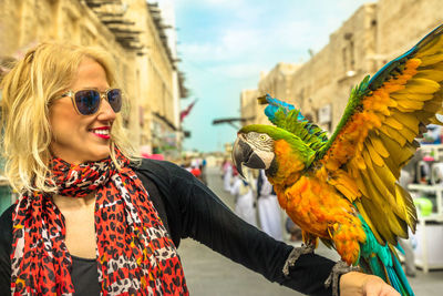 Woman with bird in city
