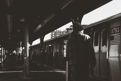 Rear view of man at station platform