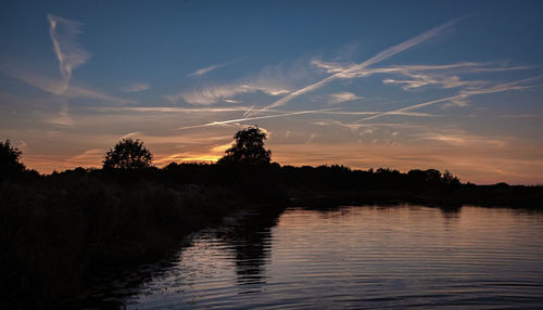 Scenic view of lake against sky during sunset