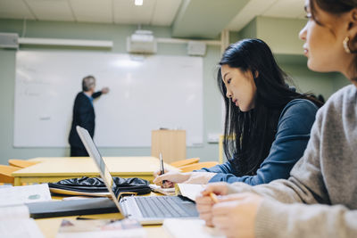 Female students during lesson in classroom