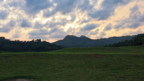 Scenic view of field against sky during sunset