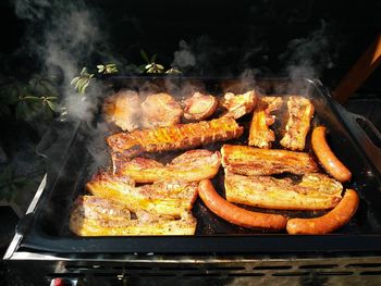 High angle view of meat cooking on barbecue grill