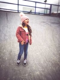 Girl looking away while standing outdoors