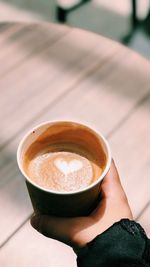 Person holding coffee cup