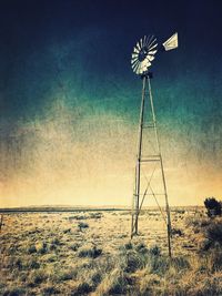 Traditional windmill on field against sky