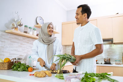 Woman standing by food at home