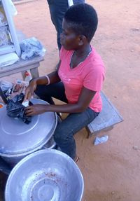 High angle view of woman sitting outdoors