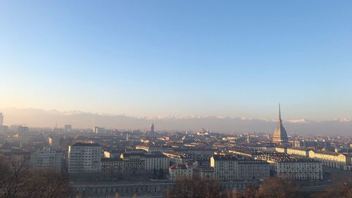 High angle view of city buildings against clear sky