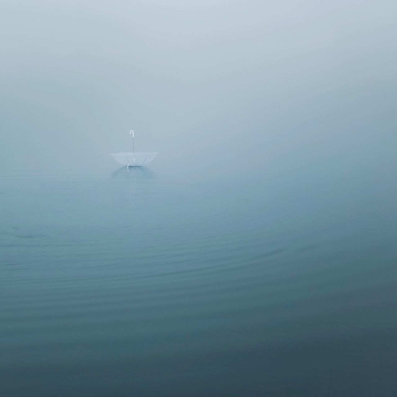 water, waterfront, tranquility, tranquil scene, fog, scenics, nature, foggy, beauty in nature, sky, day, idyllic, outdoors, no people, rippled, weather, remote, calm, non-urban scene, seascape, ocean