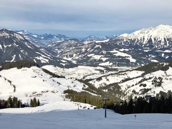 Scenic view of snow covered mountains against sky