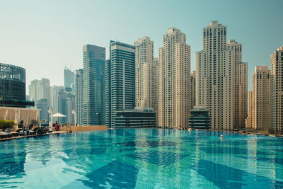 Dubai city in the uae. dubai marina. modern buildings by swimming pool in city