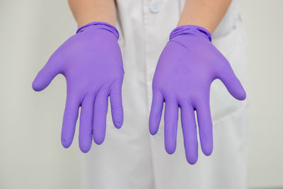 Close-up of human hand against blue background